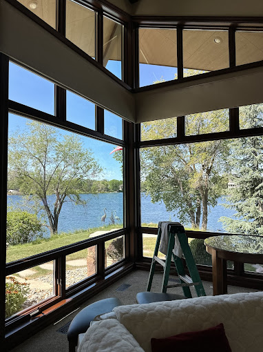 Scenic lake view through large windows of cozy interior space