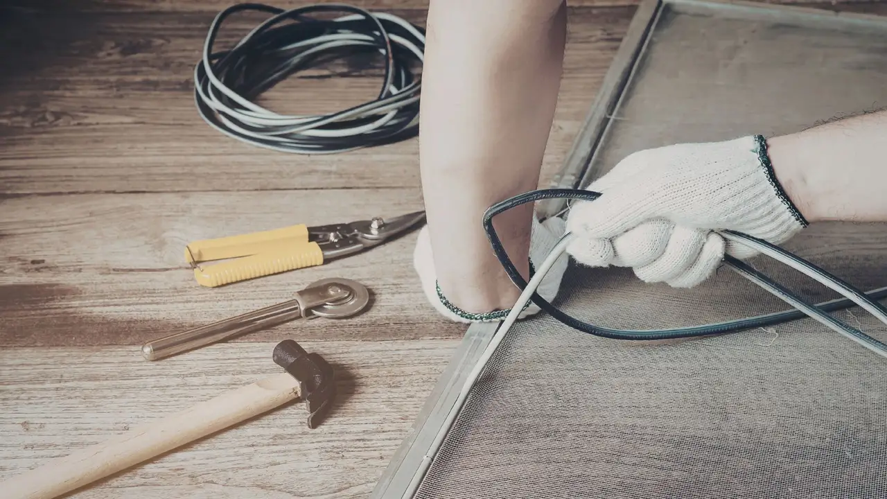 Repairing and re-screening a window screen with professional tools