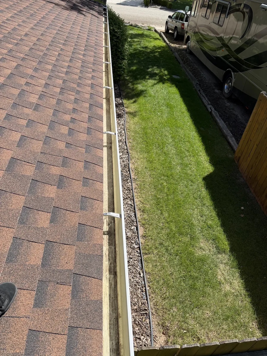 Clean, debris-free gutters along a Treasure Valley roofline after professional gutter cleaning